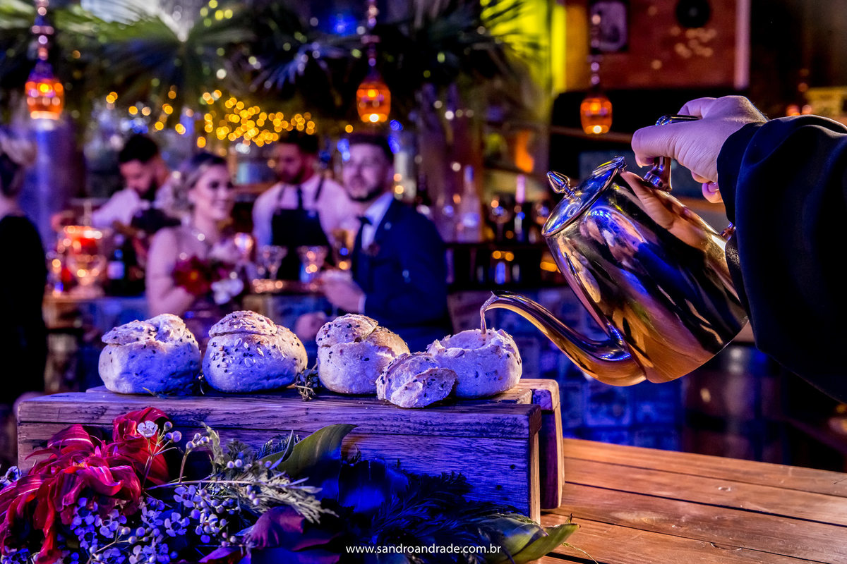 O metre do Buffet Andreia Salles colocando o molho no pão.