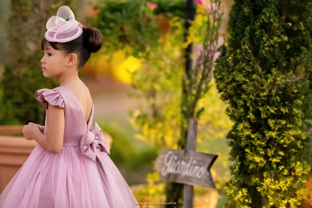 A irmãzinha da noiva está a coisinha mais linda, toda de rosa, com um chapeuzinho igual ao da mãe. 