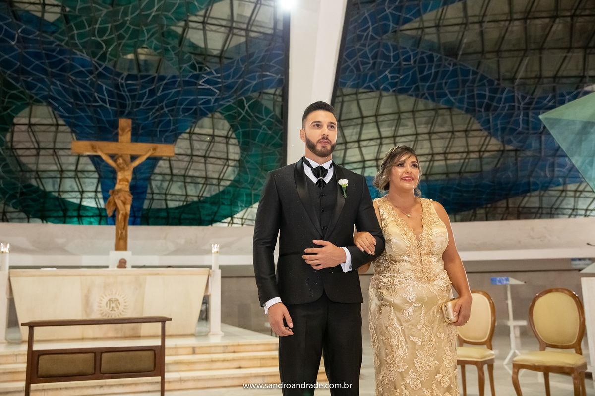 Sandro está ao lado de sua mãe no altar.