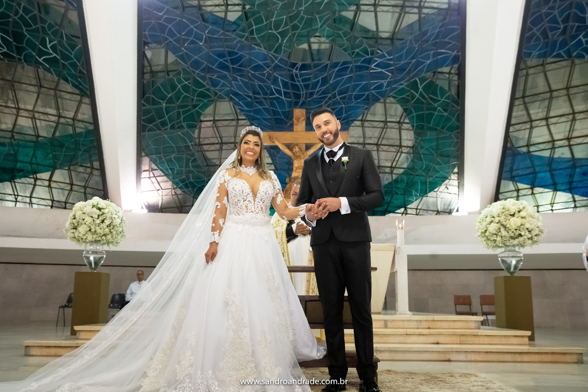 Os noivos estão de frente no altar vendo a entrada das alianças, conduzidas pelo avô do noivo.