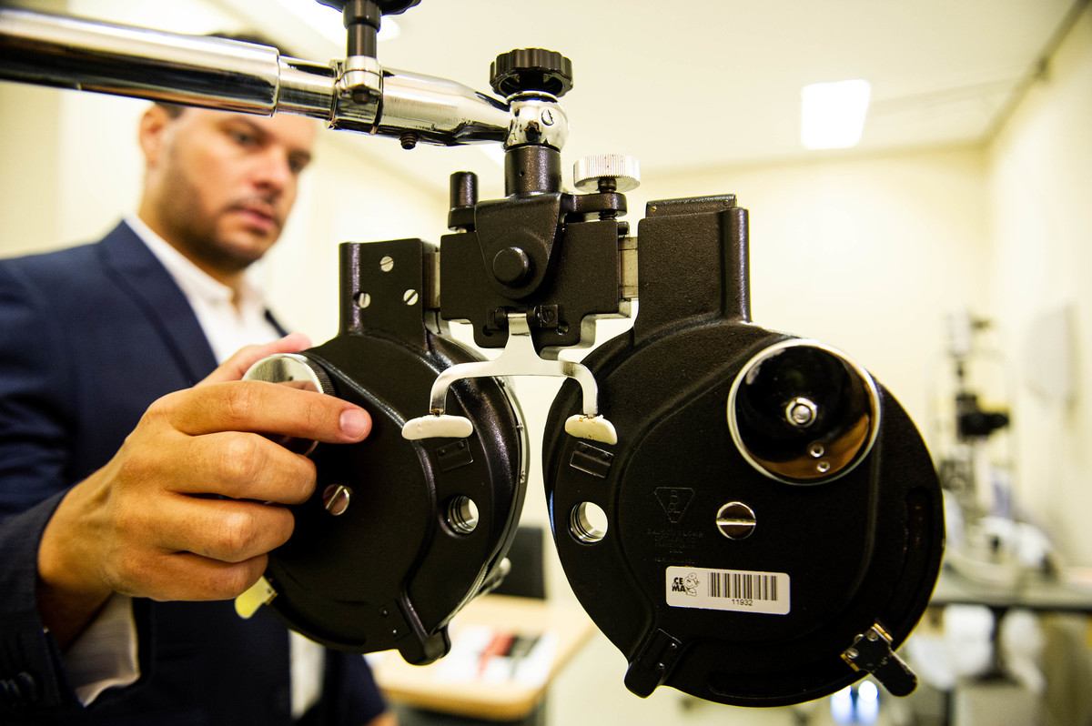 Dr Robson Assunção Oftalmologista em ação num exame de vista em seu Consultório
