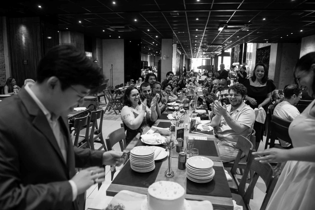 fotografia-mini-wedding-restaurante-sp-momento-descontraído-após-o-corte-do-bolo-noivos-foto-preto-e-branca.jpg