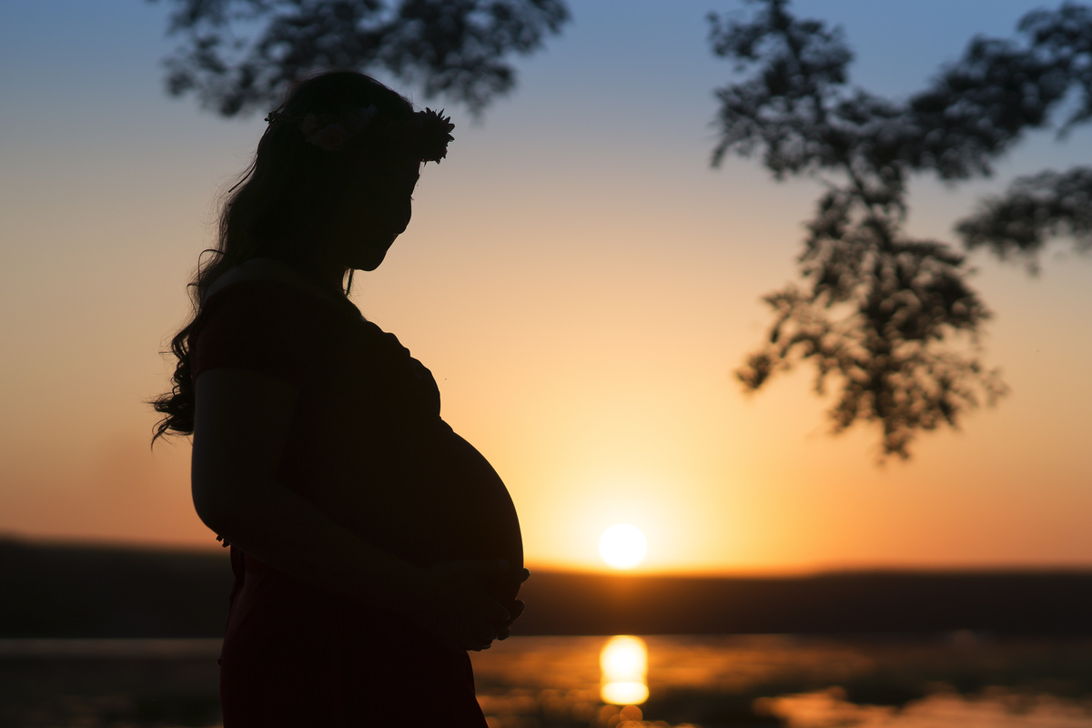 grávida no pôr do sol