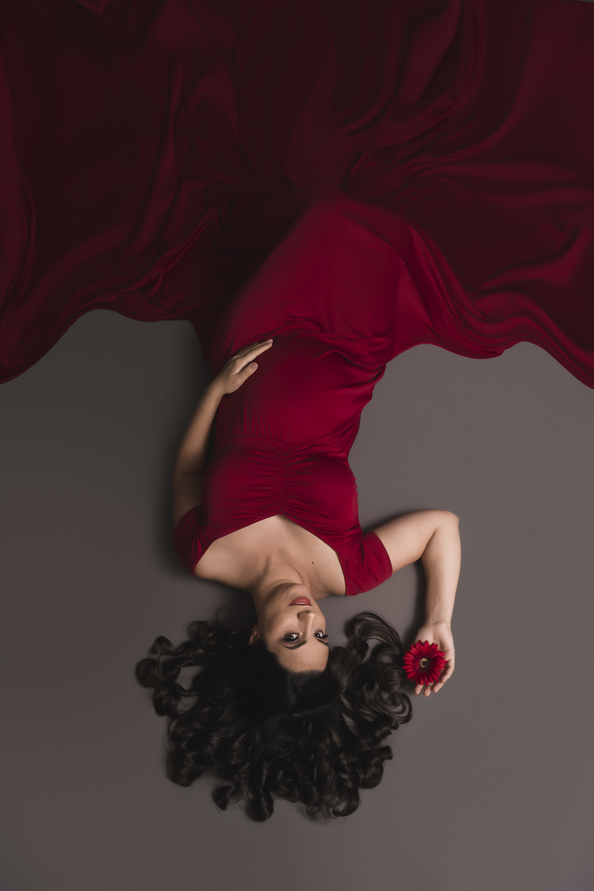 gestante deitada de vestido vermelho