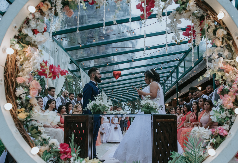 casamento ao ar livre de dia com noiva princesa e noivo de terno azul e gravata borboleta de madeira decoracao com guirlanda e padrinhos com balao de coracao