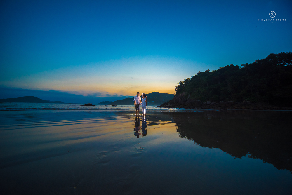 ensaio casal com por do sol balao data e foto incrivel na praia das conchas iporanga no guaruja com a fotografa nayara andrade noiva de vestido longo branco