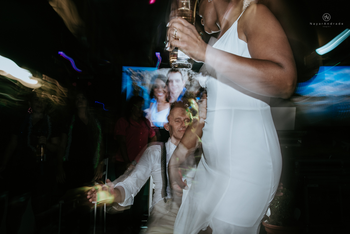 casamento italobrasileiro entre italiano e brasileira em lugar rustico ao ar livre de dia em clima descontraido noivo de all star noivo loiro e noiva negra tema com uvas e italia