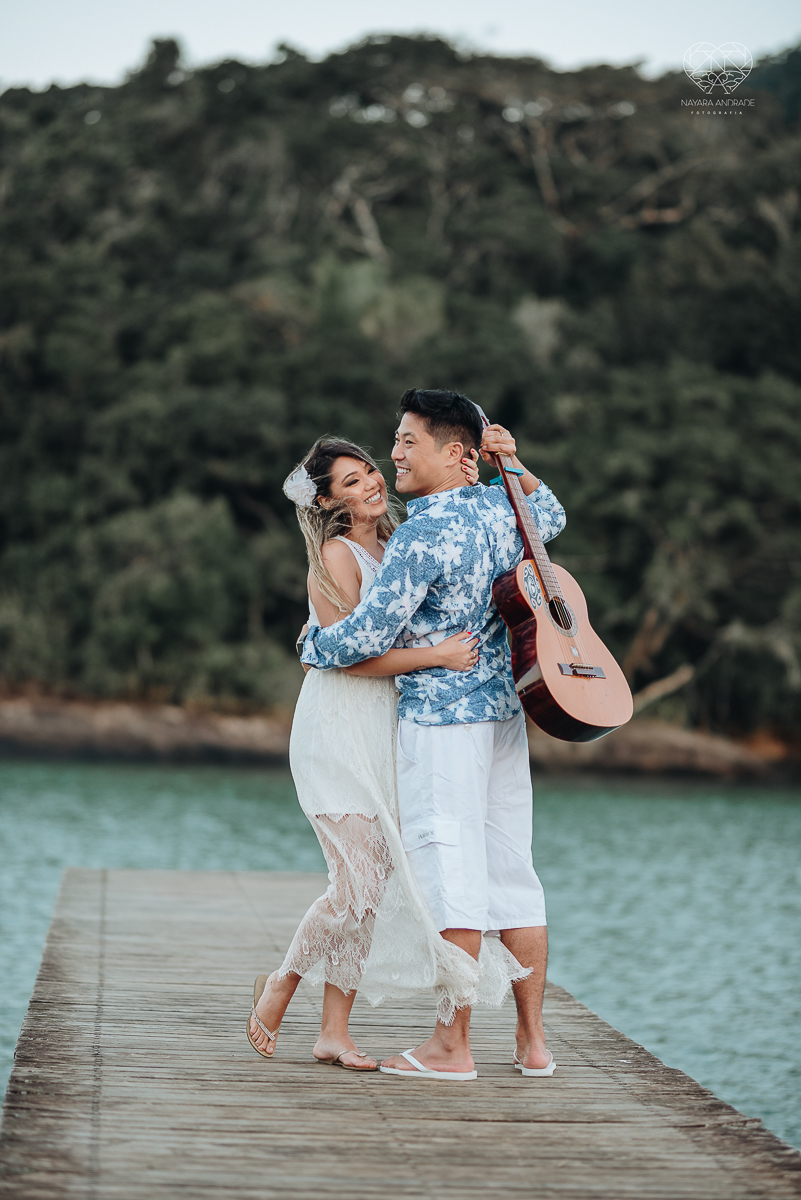 Ensaio pre wedding de casal japones niponico feito em itariri em sao paulo pela fotografa premiada nayara andrade. Noivo de camisa jeans e noiva de roupa florida