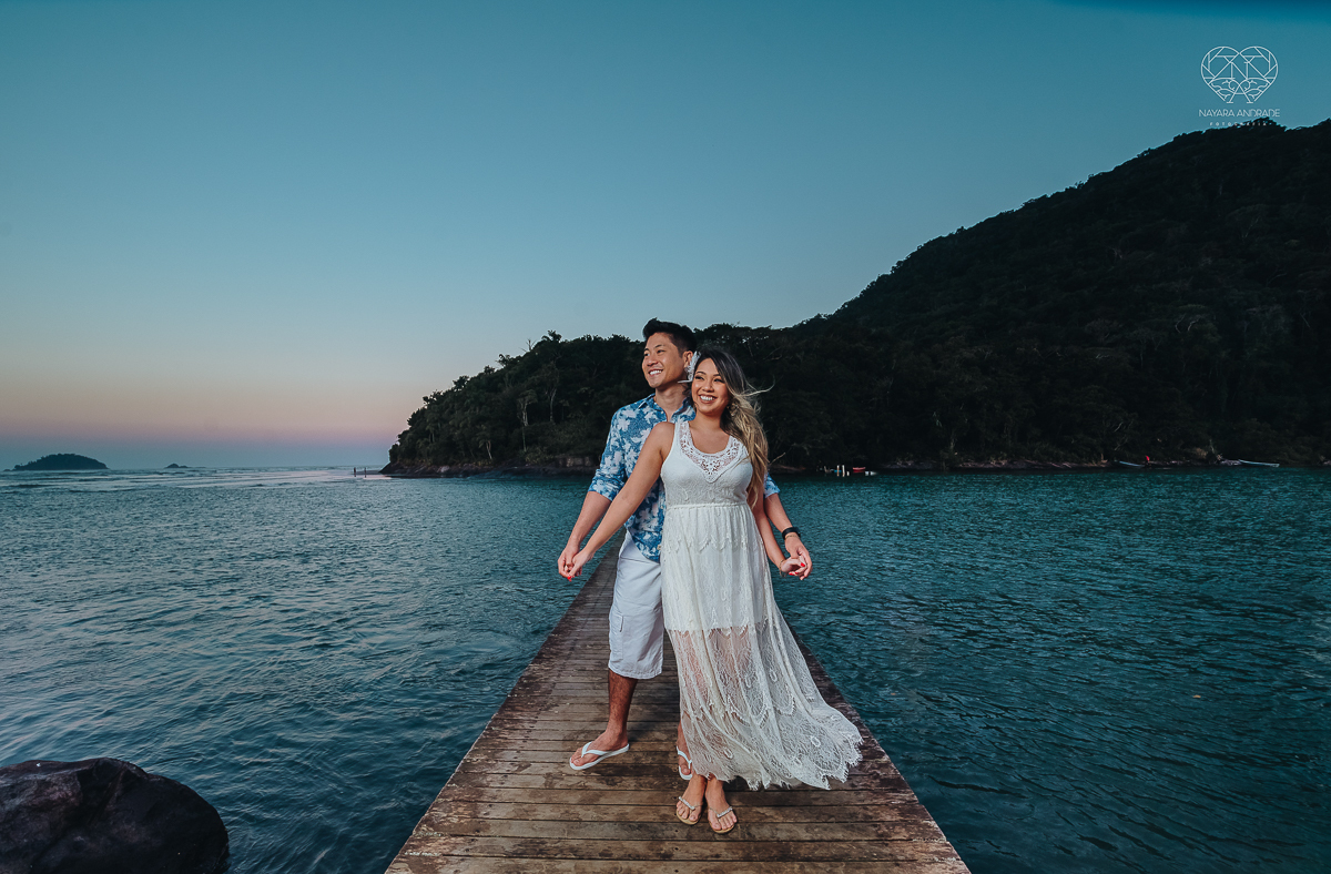 Ensaio pre wedding de casal japones niponico feito em itariri em sao paulo pela fotografa premiada nayara andrade. Noivo de camisa jeans e noiva de roupa florida