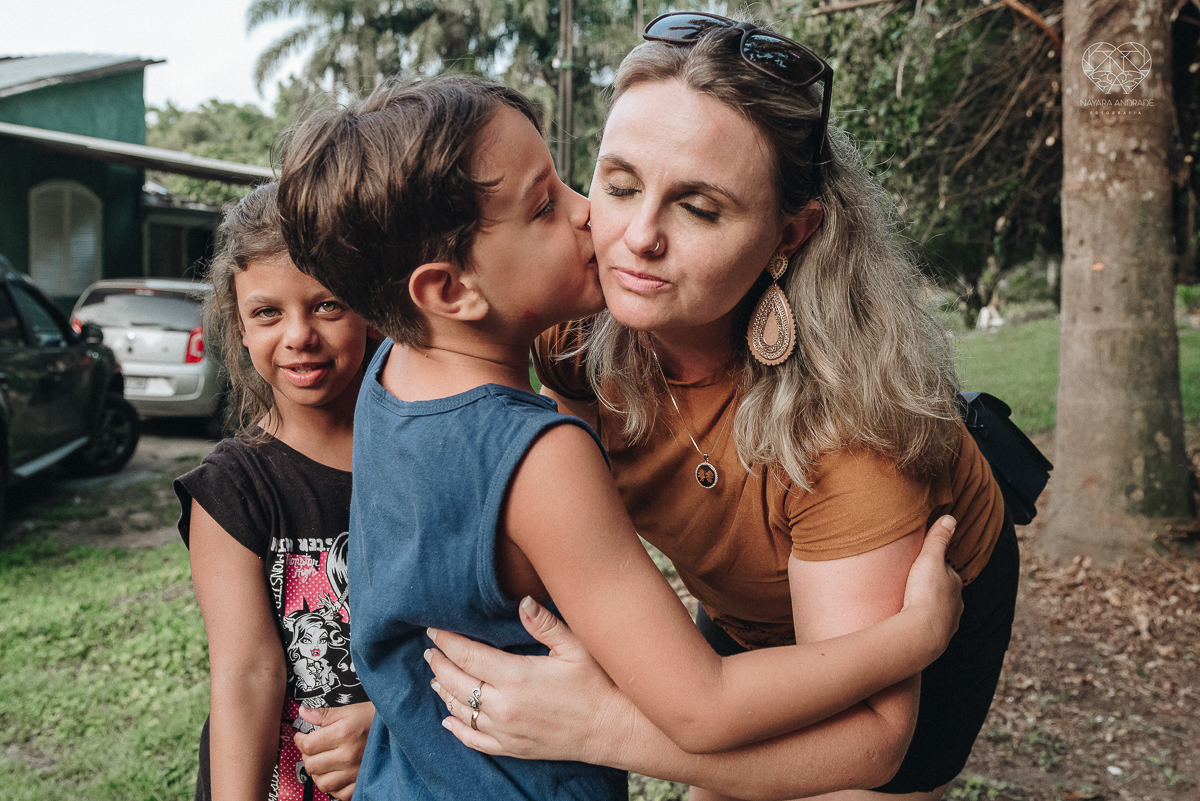 ensaio familia lifestyle brincando de mangueira no quintal de casa com o papai crianças e o cachorro fotografado pela fotografa premiada nayara andrade nayara andrade fotografia
