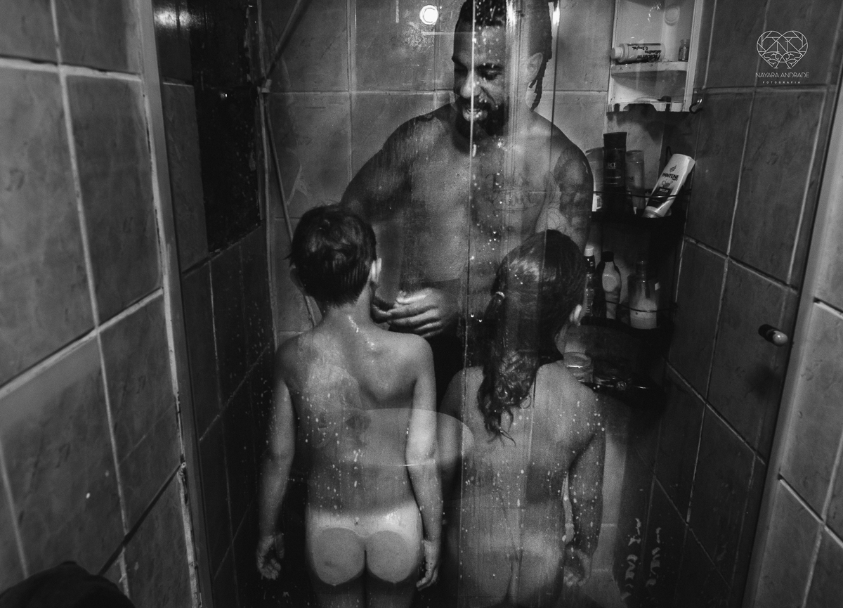 ensaio familia lifestyle brincando de mangueira no quintal de casa com o papai crianças e o cachorro fotografado pela fotografa premiada nayara andrade nayara andrade fotografia