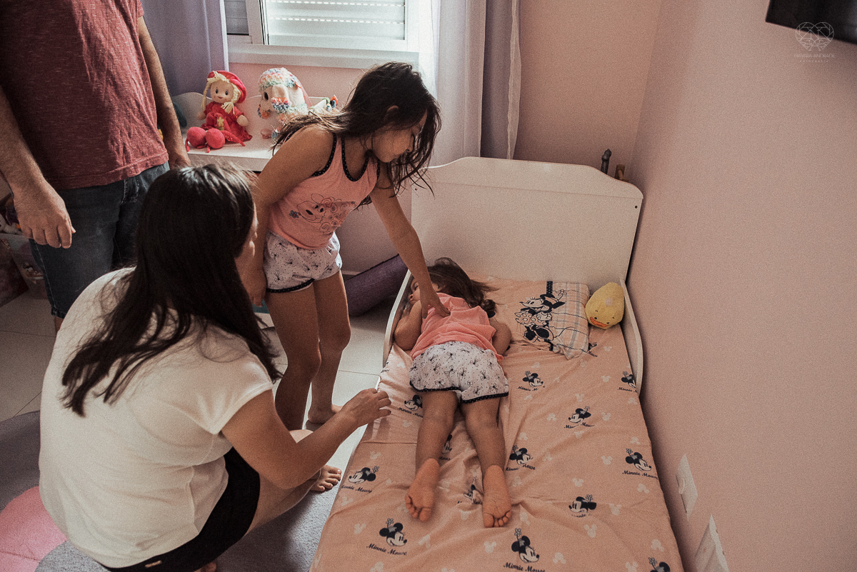 Fotografia de familia fotos feitas em casa ao natural da familia mae pai e duas filhas com pijama acordando brincando no predio. fotos feitas pela fotografa premiada nayara andrade de santos litoral de sao paulo