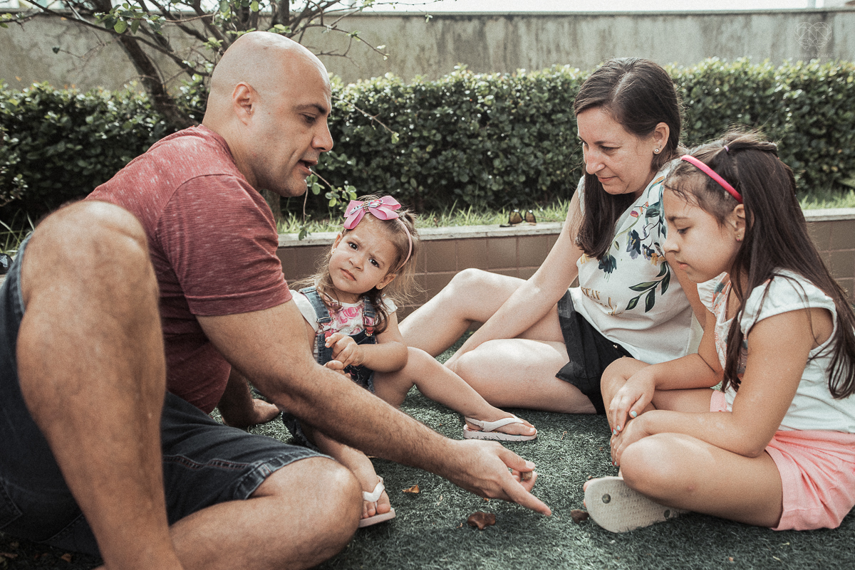 Fotografia de familia fotos feitas em casa ao natural da familia mae pai e duas filhas com pijama acordando brincando no predio. fotos feitas pela fotografa premiada nayara andrade de santos litoral de sao paulo