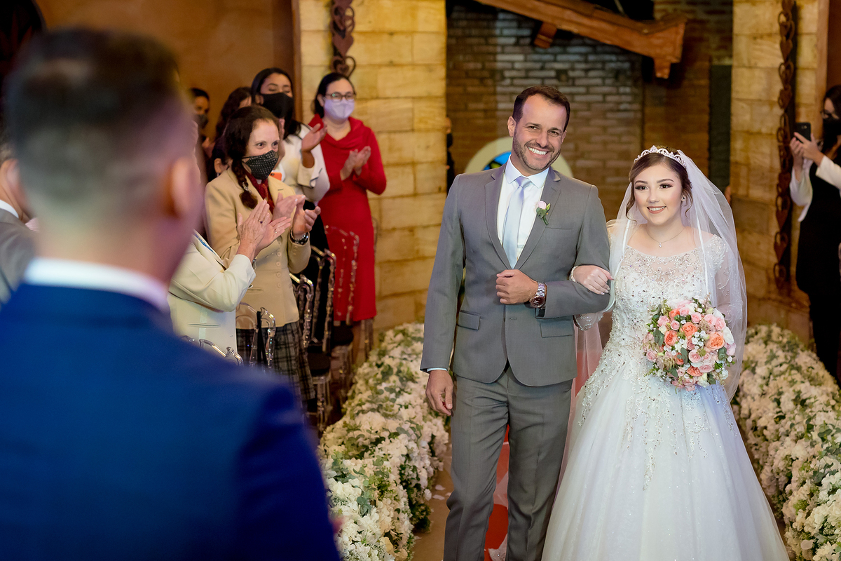 Noiva entrando com seu pai no corredor 