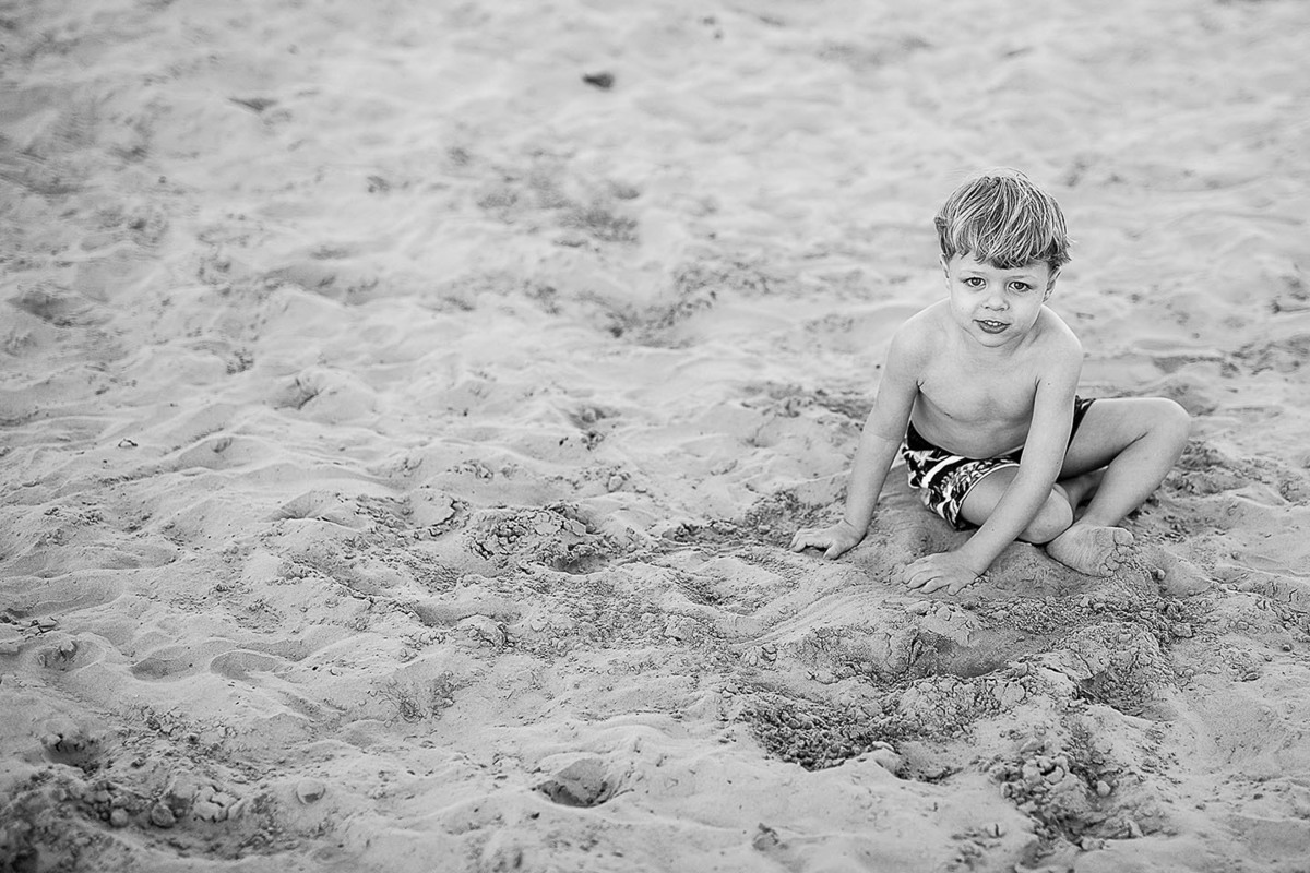 foto Ilha do Porchat - santos - praia de são vicente - fotografia Paulo Araujo, ensaio de família, lifestyle, menino brincando na areia, fazendo castelo