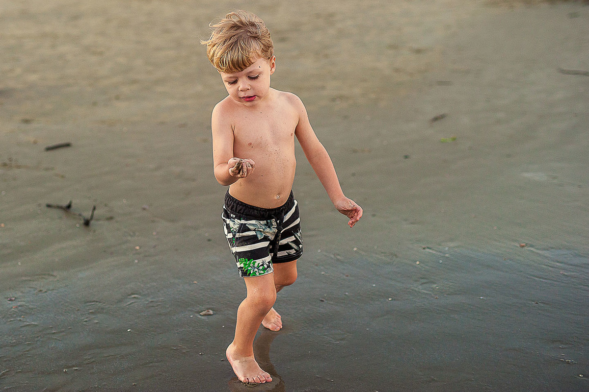 foto Ilha do Porchat - santos - praia de são vicente - fotografia Paulo Araujo, ensaio de família, lifestyle, mãos suja de areia da praia, criança brincando.