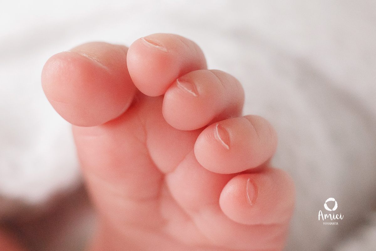 Fotografia macro, destacando os detalhes dos dedinhos do pezinho do recém nascido.