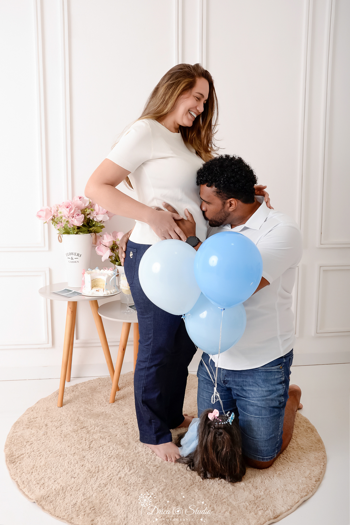 drica studio -ensaio fotografico adulto - chá revelação - sexo do bebê - xinguara - pará - esposo acarecia e beijabarriga da esposa - balões azuis presos a cachorrinha preta - vaso com flores rosa - funco clean - 