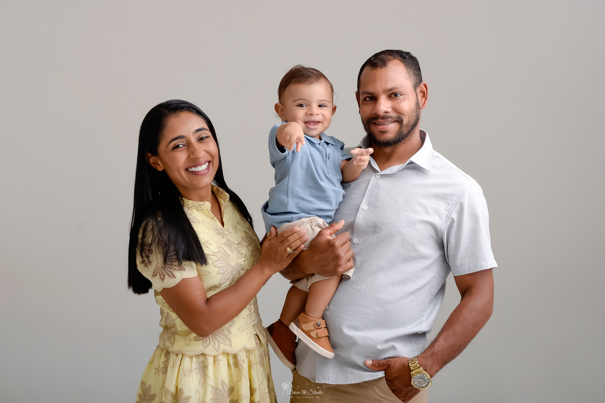 Drica studio - ensaio infantil - ensaio de 1 ano - smash the cake - arca de noé - acompanhamneto mensal - mãe, pai e filho - foto em fundo branco - bebe usando camisa gola polo azuk claro - 