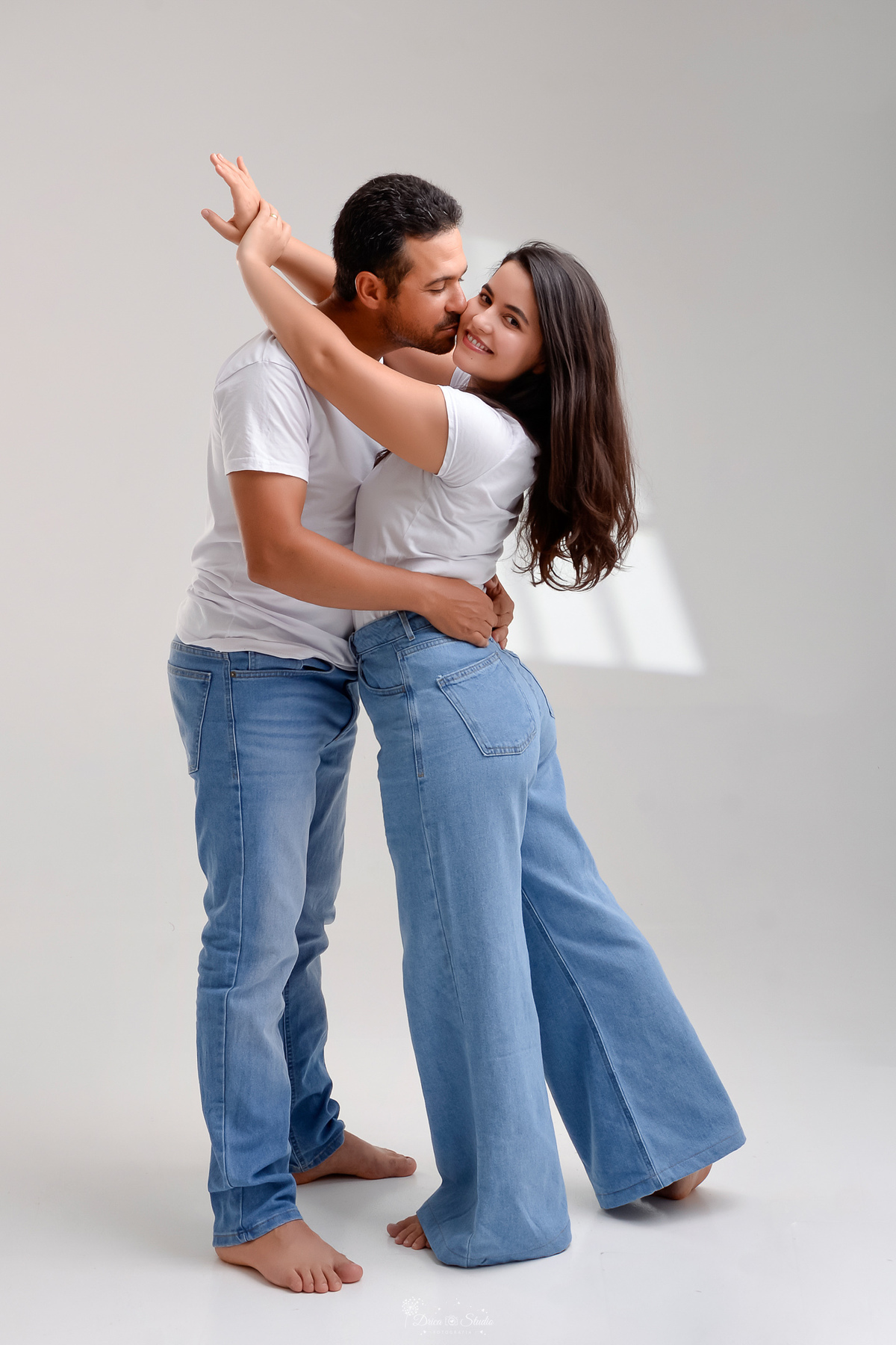 Ensaio casal - ensaio fotografico - fotos em estudio - drica studio - xinguara - pará - casal usando camisas brancas e calças jeans - casal abraçados - 