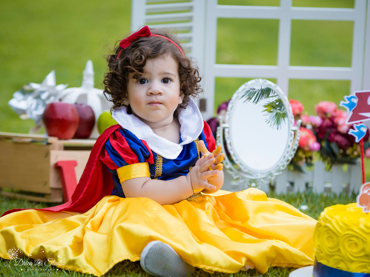  Smash the Cake- Branca de Neve- sorrindo-com bolo -Xinguara- Pará- ensaio infantil- ensaio externo- ensaio de família- contos de fada- grama verde- amarelo- Fotógrafa- Drica Studio- Fotografia de família- fotografa em Xinguara- cenário- lindo. 