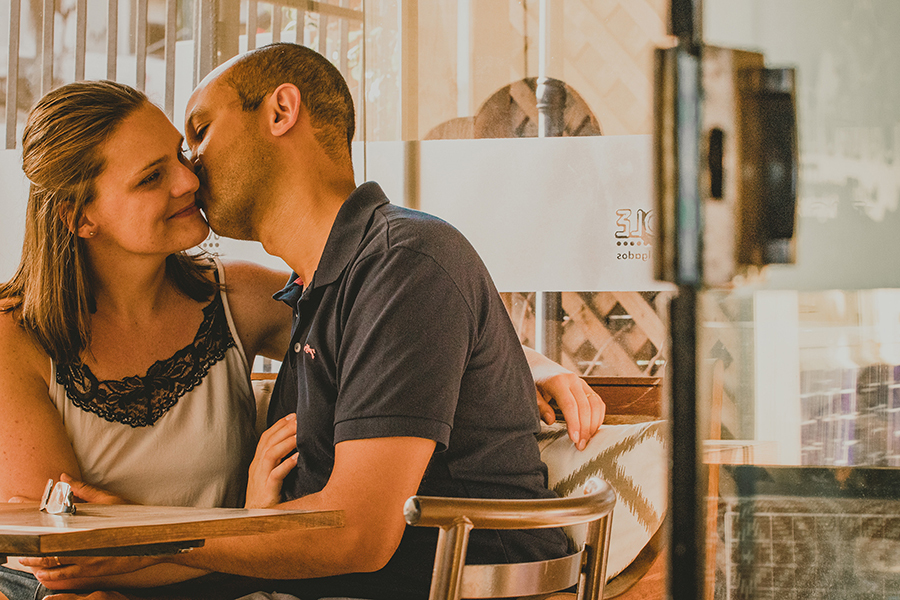 homem beijando mulher sentados