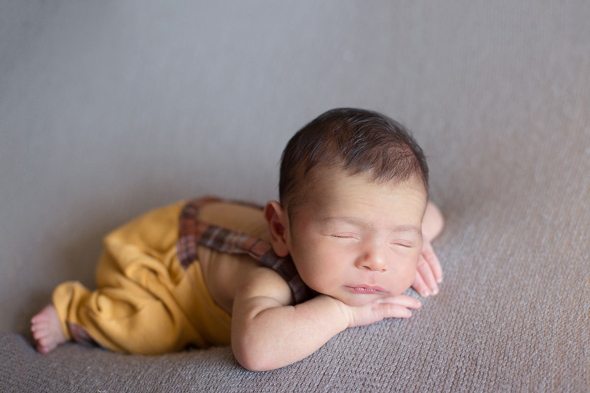 Ensaio newborn a domicilio ensaio em casa de recem nascido Gabriel pose do bracinho em composição cinza amarelo mostarda