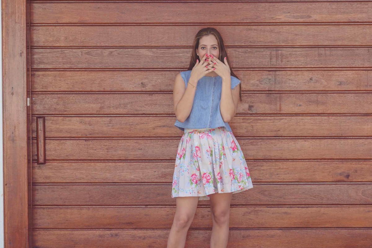 Fotografia da blogueira Fofuras da Ka com as mãos tapando sua boca mostrando as unhas durante o ensaio fotográfico em Itanhaém - Cia P&b - Fotografia 