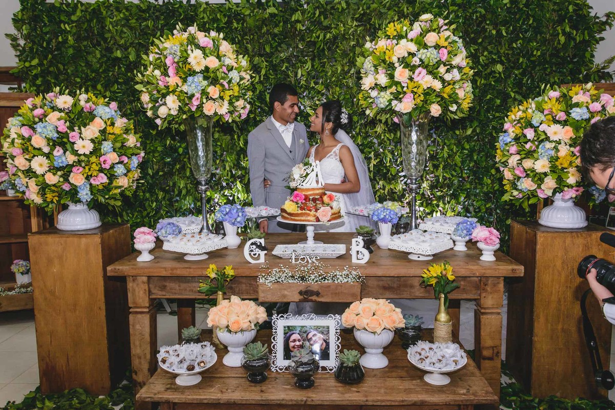 Foto dos Noivos na mesa do bolo decorada na festa - Hípica de Itanhaém - fotografia Cia P&B Produções  