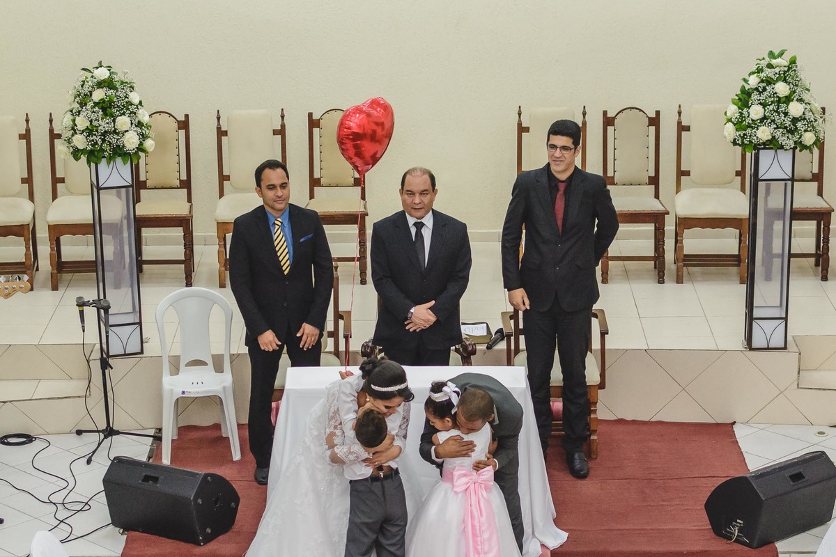 Noivos abraçando a daminha e o pagem na cerimônia de casamento em Praia Grande - SP - fotografia Cia P&B Produções 