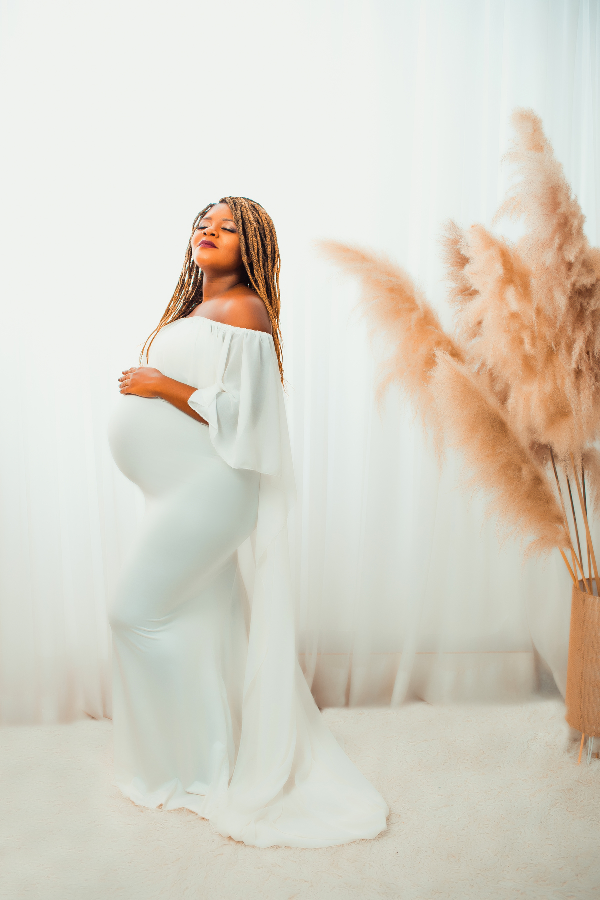 No cenário clean, Larissa Lacerda brilha em sua essência de gestante radiante. O ambiente minimalista e delicado realça sua beleza natural, enquanto o vestido branco enaltece sua graciosidade.