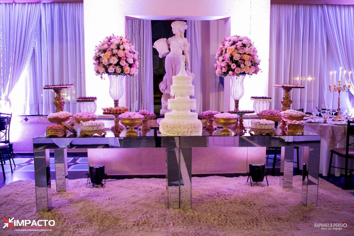Mesa de doces de casamento espelhada com arranjos em tons de rosa