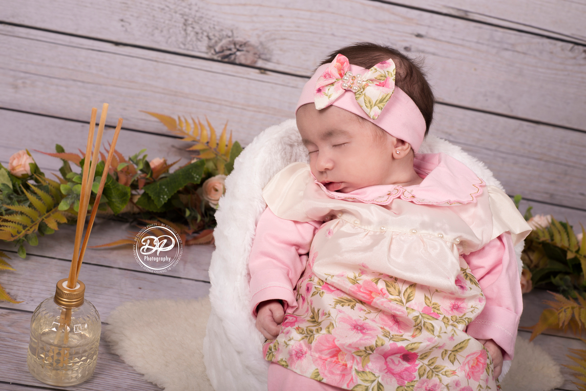 Bebê Isabela deitada dormindo tranquilamente em seu ensaio de 1º mês de vida