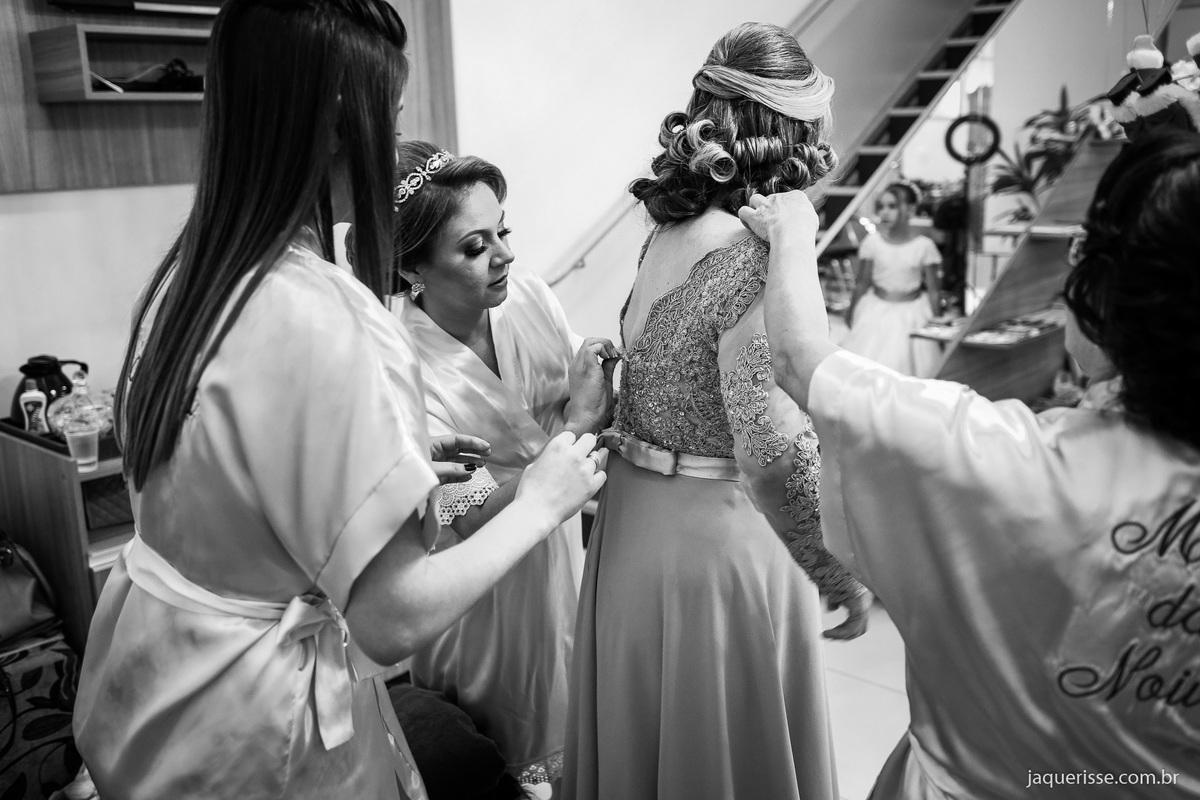 noiva, sua mãe e madrinha arrumando o vestido de uma das madrinhas durante o making off fotografado pela jaque risse