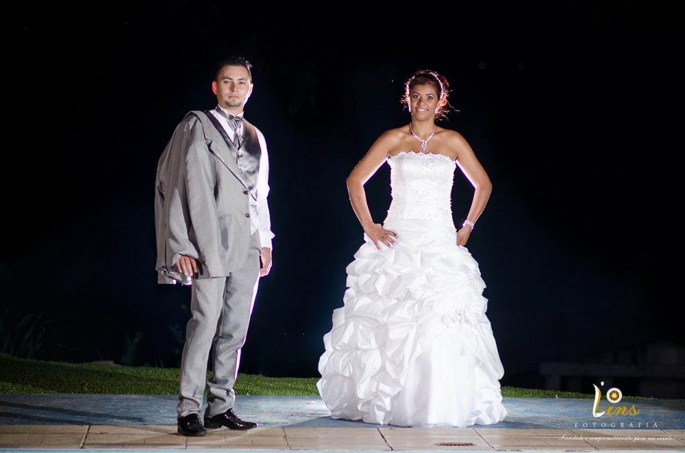 noivos posando em frente a piscina