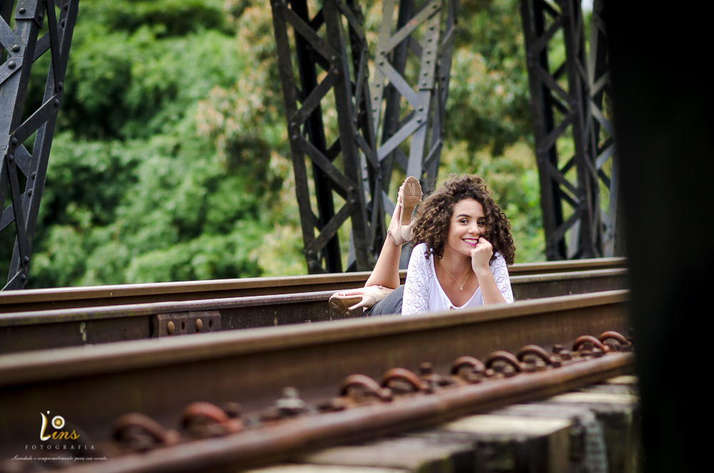 debutante fazendo pose deitada em trilho de trem em guararema