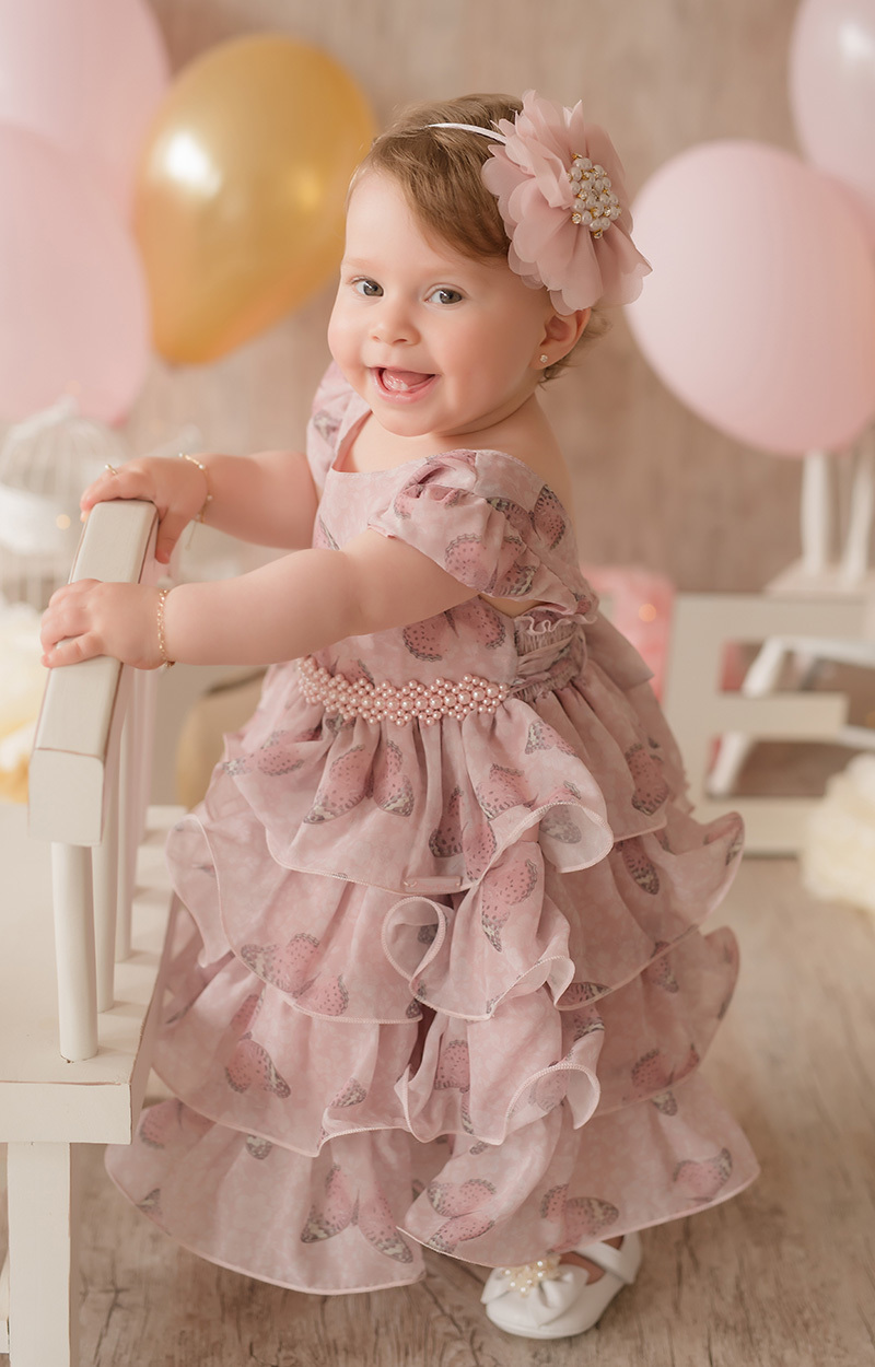 foto de bebe em caxias do sul fotografa morgana perini menina segurando na cadeira