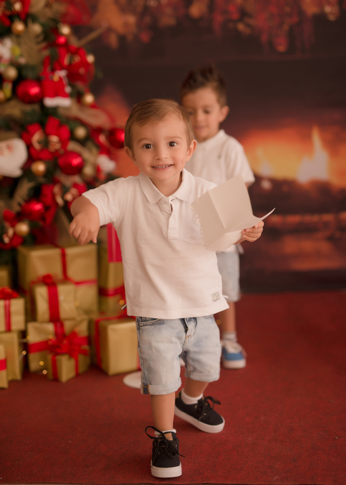 foto de familia em caxias do sul fotografa morgana perini menino de camisa branca com papel na mão