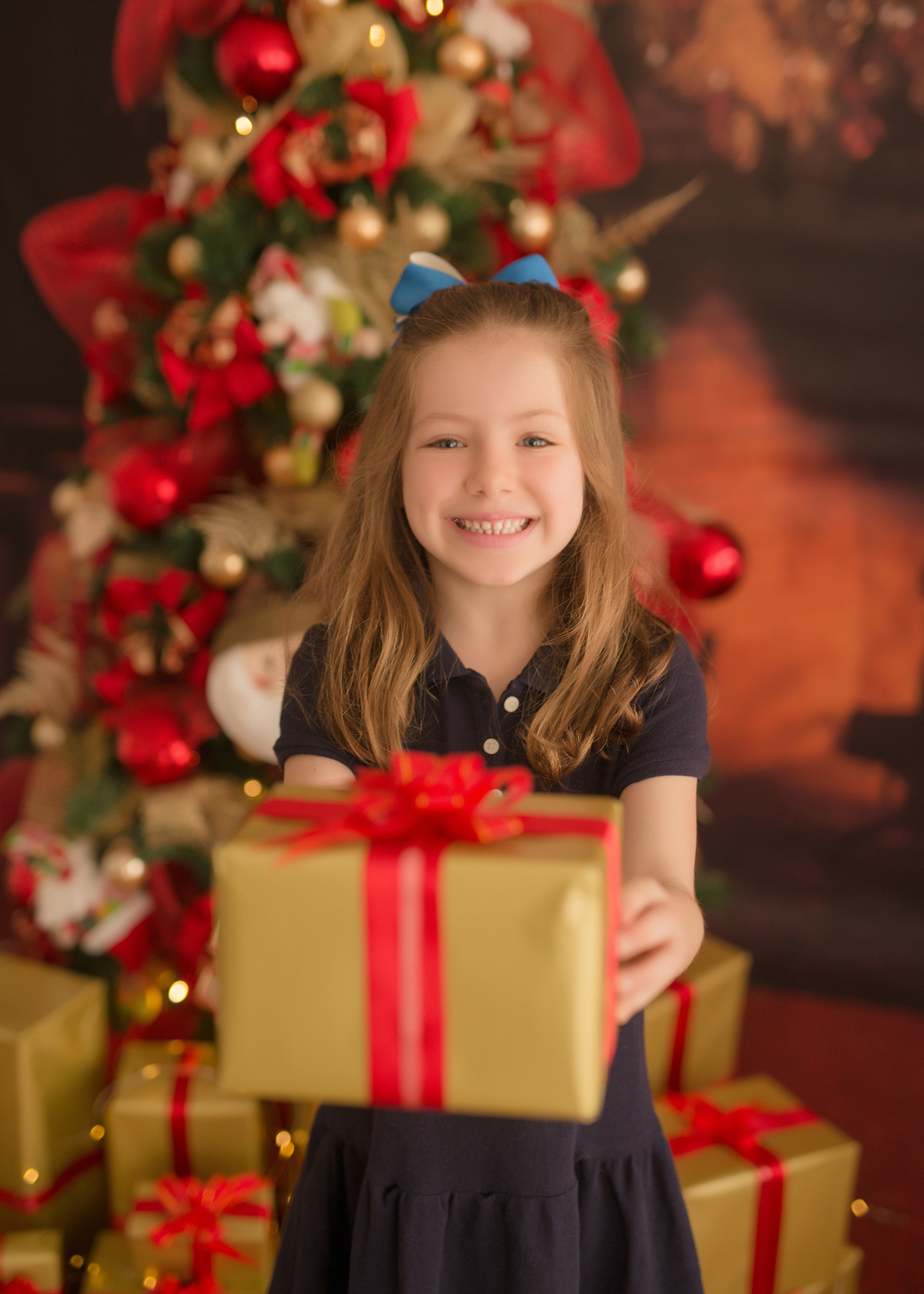 foto de familia em caxias do sul fotografa morgana perini menina com camisa azul com presente