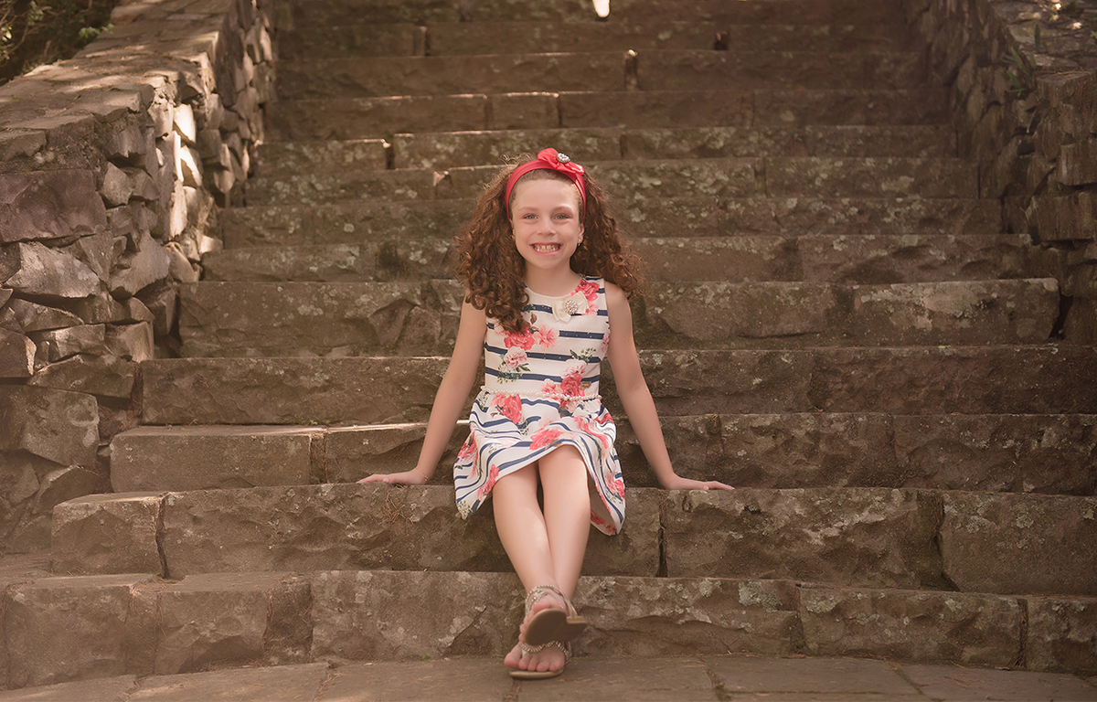 foto de menina em caxias do sul fotografa morgana perini menina de vestido sentada em escada de pedra
