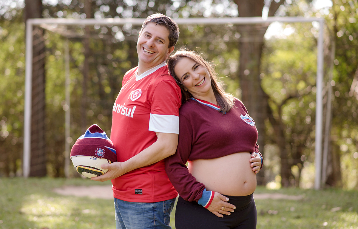 foto de gestante em caxias do sul fotografa morgana perini pais em campo de futebol
