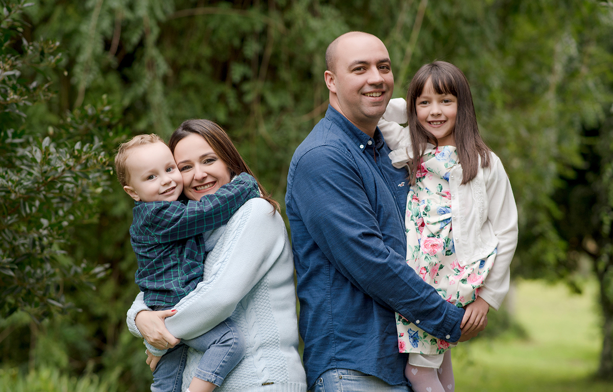 foto de familia em caxias do sul fotografa morgana perini pais com os filhos no colo roupas em tons de azul