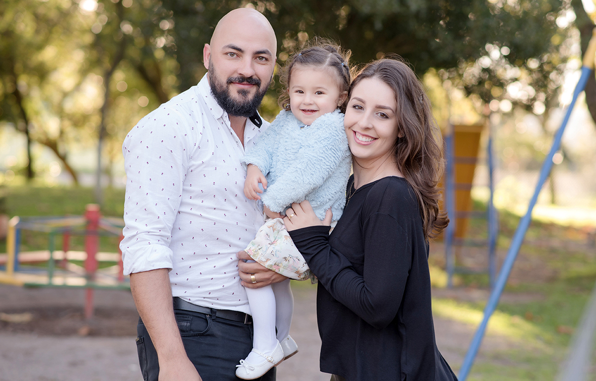foto de criança em caxias do sul fotografa morgana perini menina no colo do pai mae abraçando 
