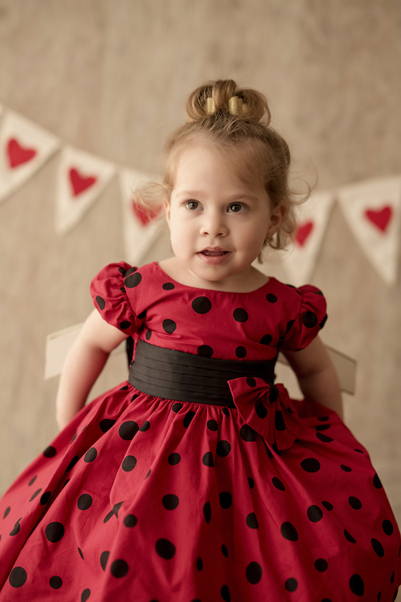 Foto criança em caxias do sul fotografa morgana perini menina sentada cadeira vestido vermelho