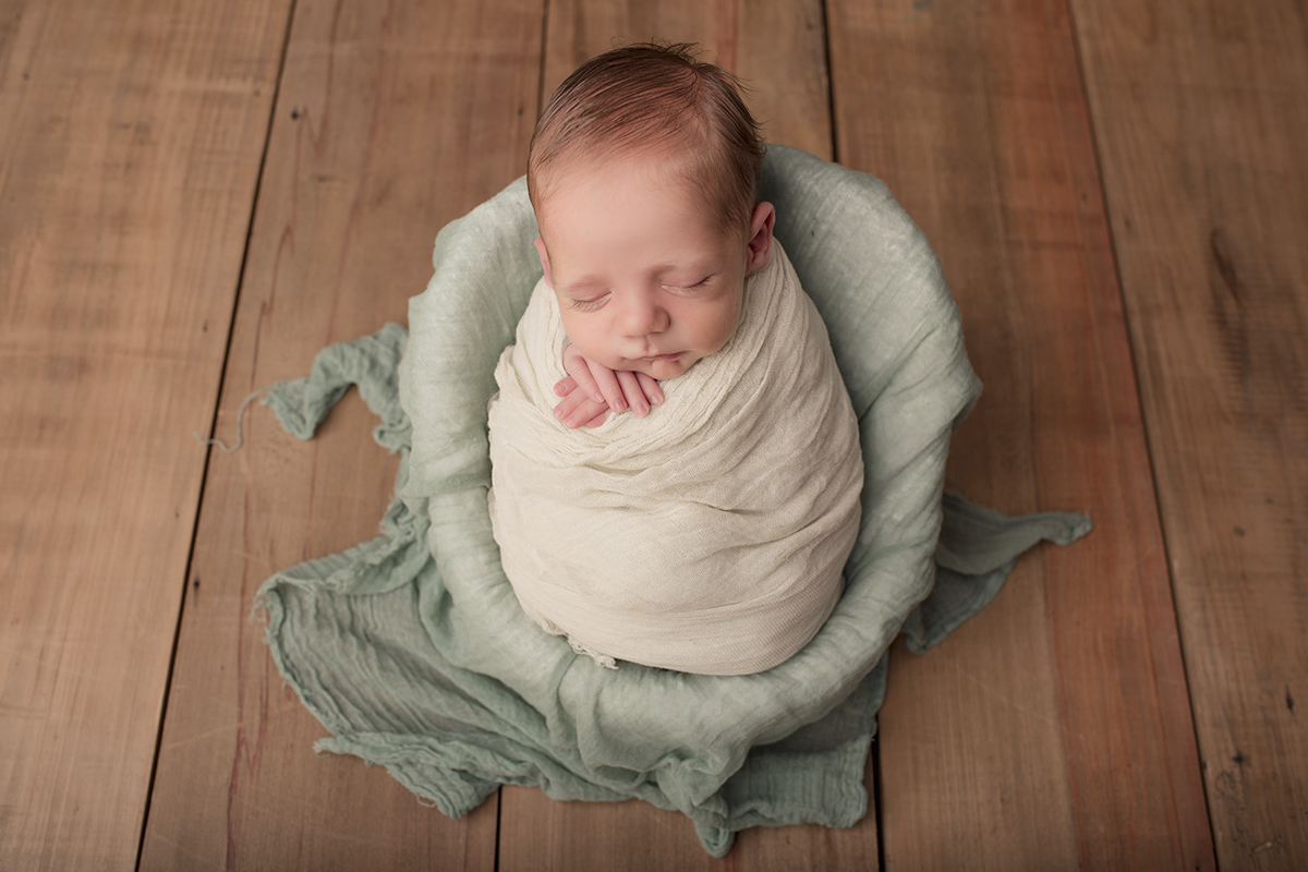 Foto newborn em caxias do sul fotografa morgana perini bebe enrolado verde