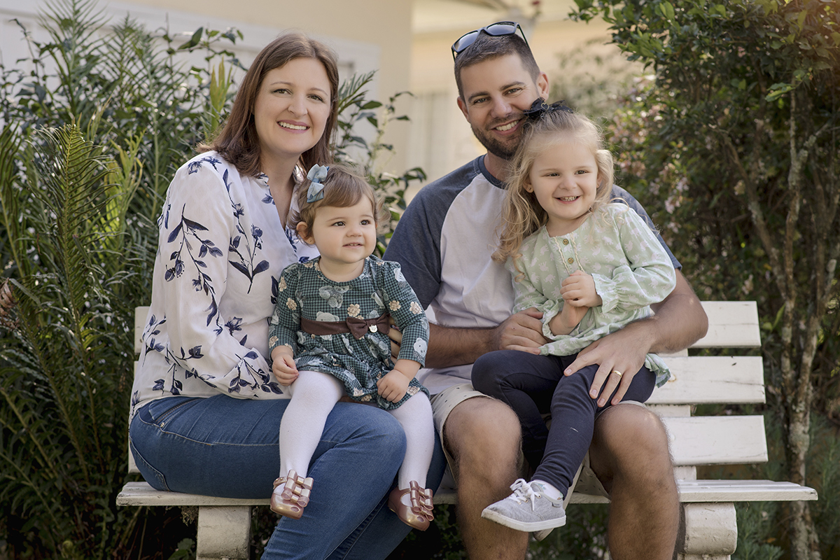 Foto de bebe em caxias do sul fotografa morgana perini pais com as filhas sentados no banco branco