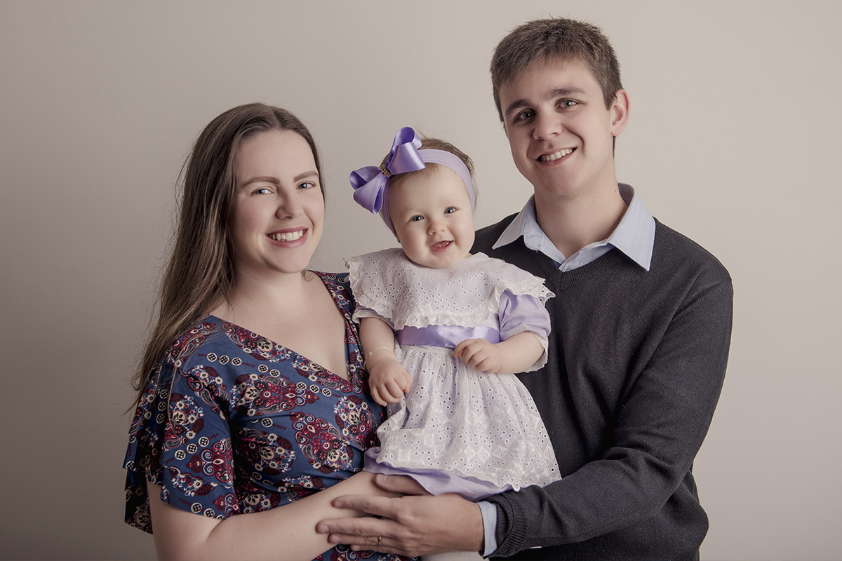 Foto de bebe em caxias do sul fotografa morgana perini pais com menina com vestido e laço roxo