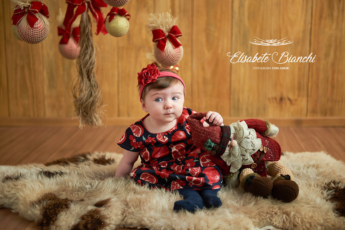 Bebê sentadinho em pelego, em ensaio de natal, em estúdio, Caxias do Sul - RS.