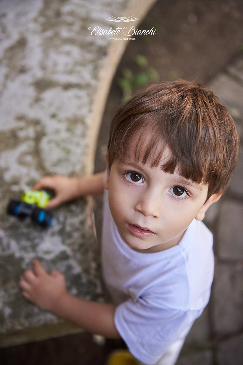 Criança brincando com um carrinho, em ensaio infantil com a família, em Caxias do Sul - RS.