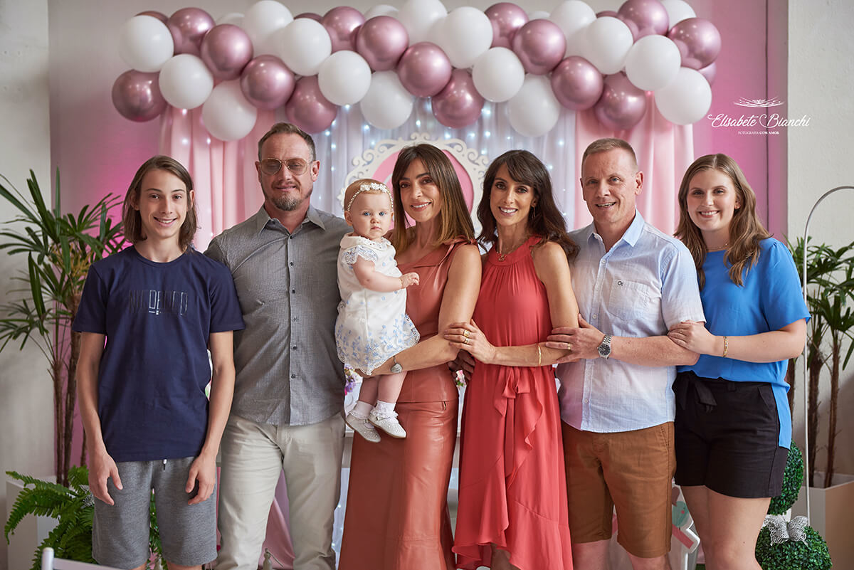 Família com dindos e primo, com a aniversariante, em festa de 1 ano em Caxias do Sul.